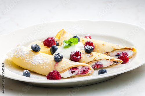 pankaces filled with blueberries, raspberries and cream