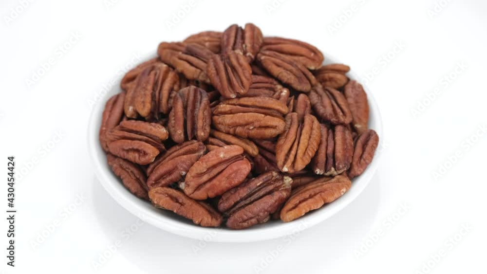 raw pecan nuts isolated on white background, rotation. Healthy food concept. 4K UHD video raw pecan nuts isolated on white background, rotation. Healthy food concept. 4K UHD video