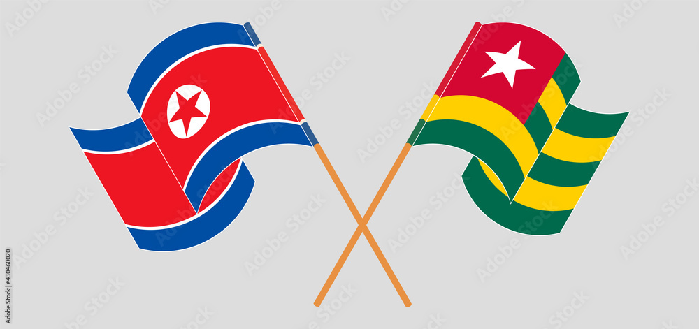 Crossed and waving flags of North Korea and Togo Crossed and waving flags of North Korea and Togo
