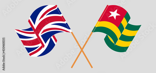 Crossed and waving flags of the UK and Togo