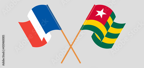 Crossed and waving flags of France and Togo