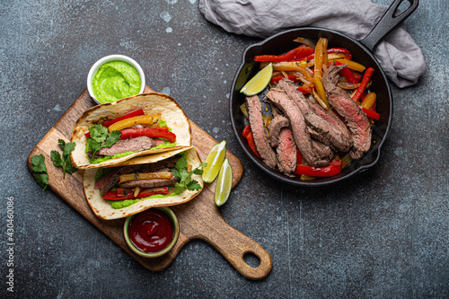 Canvastavla Process of making traditional Mexican dish Beef fajitas tacos served on wooden c