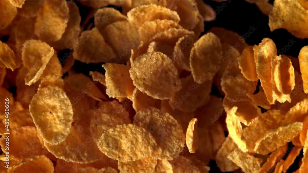 Super slow motion cornflakes are soaring up.Filmed on a high-speed camera at 1000 fps. On a black background. Super slow motion cornflakes are soaring up.Filmed on a high-speed camera at 1000 fps. On a black background.