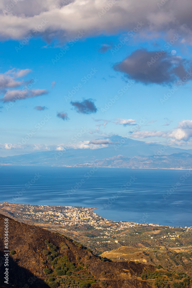 landscape illuminated by morning sun near Reggio di Calabria with island of Sicily and Mount Etna, Italy landscape illuminated by morning sun near Reggio di Calabria with island of Sicily and Mount Etna, Italy