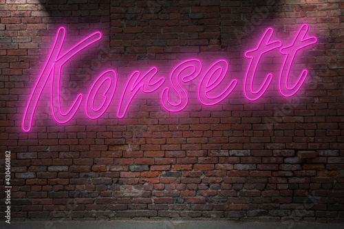 Neon corset (in german Korsett) lettering on Brick Wall at night