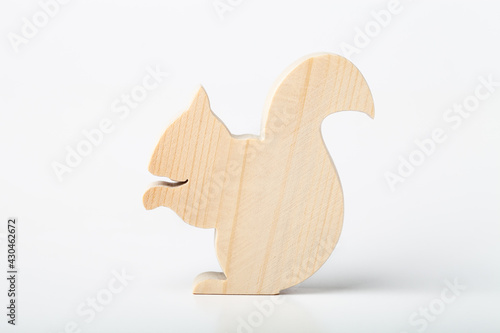Squirrel figurine carved from solid pine by hand jigsaw. On a white background
