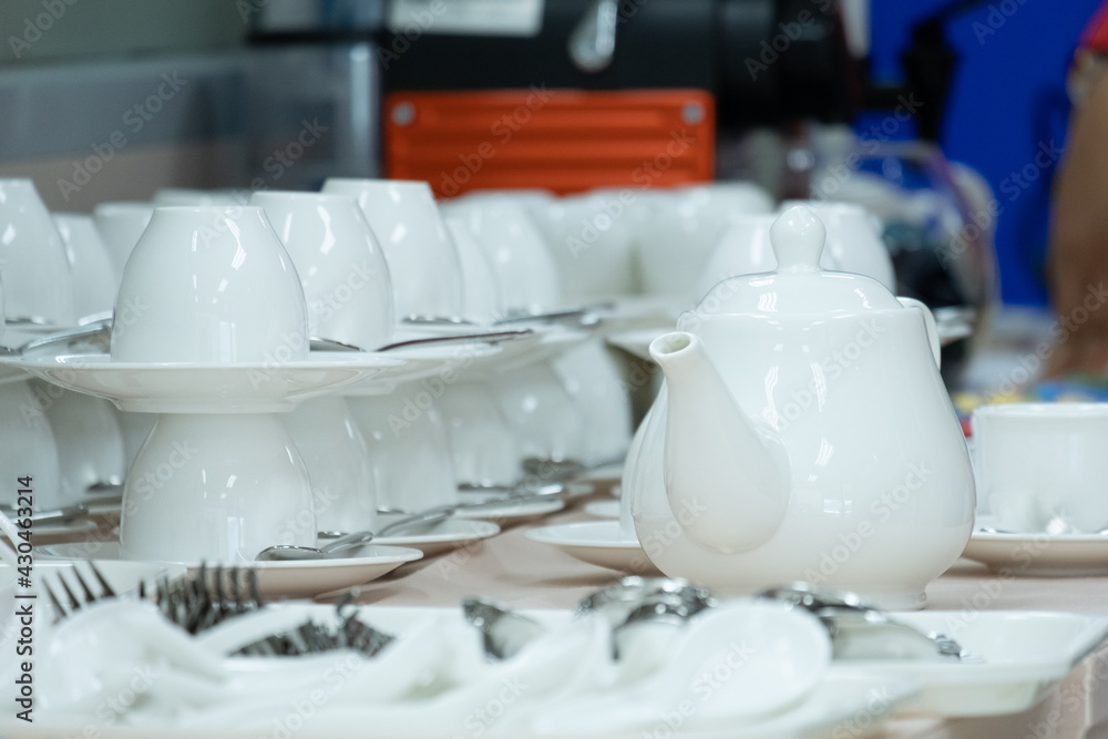 White ceramic teapot and teacup