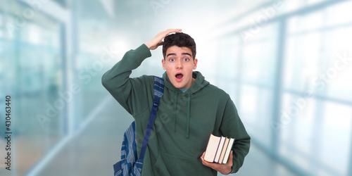 student with books and backpack and expression of surprise and forgetfulness
