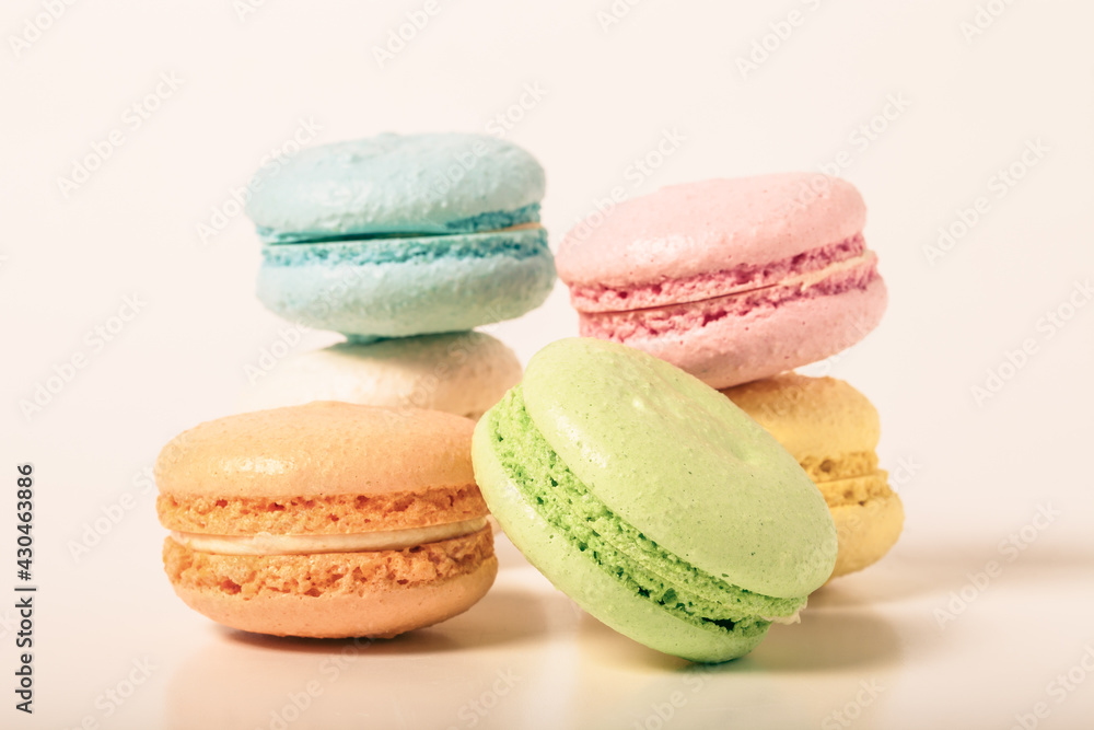 Colorful cake macaroons on a light background. Toned Colorful cake macaroons on a light background. Toned