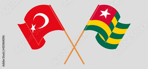 Crossed and waving flags of Turkey and Togo