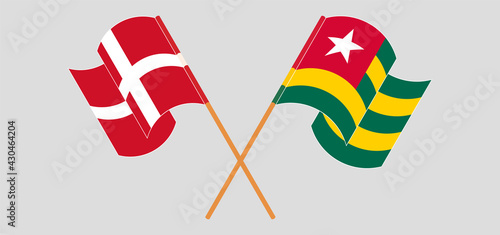Crossed and waving flags of Denmark and Togo