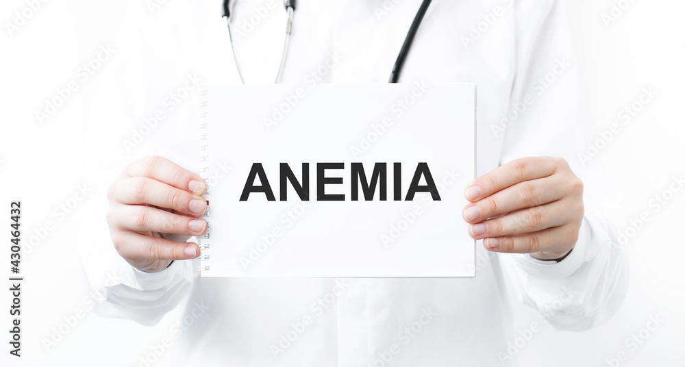 Doctor holding a card with text ANEMIA, medical concept Doctor holding a card with text ANEMIA, medical concept