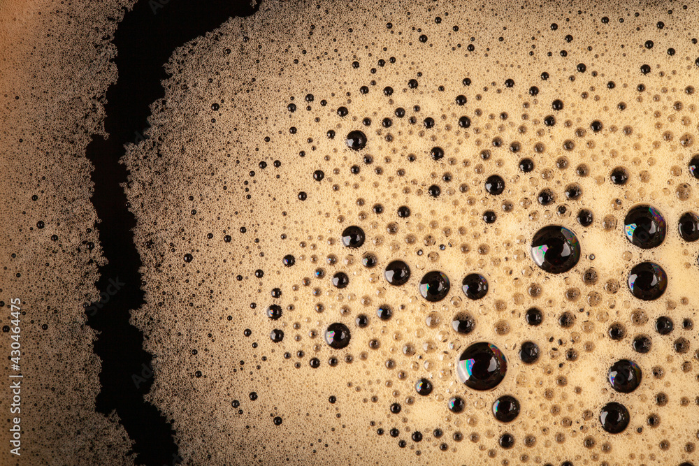 Top view to the hot fresh coffee with foam in the green cup Top view to the hot fresh coffee with foam in the green cup