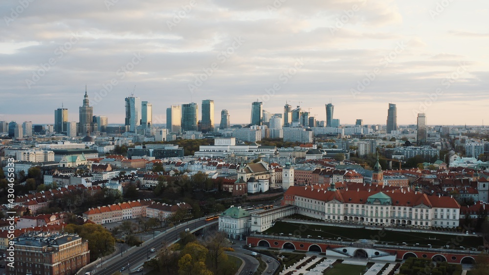 Aerial view of the old town and city. The shot is taken in the morning. City of Warsaw, Poland waking up. Skyscrapers and residential apartments against a scenic blue cloudy sky in the background.