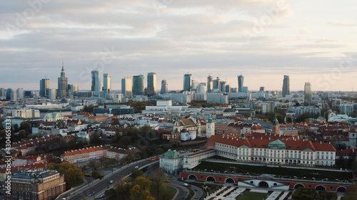 Aerial view of the old town and city. The shot is taken in the morning. City of Warsaw, Poland waking up. Skyscrapers and residential apartments against a scenic blue cloudy sky in the background.