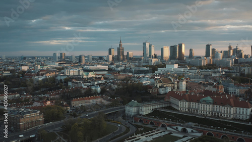 Aerial view of the old town and city. The shot is taken during dawn. City of Warsaw, Poland waking up. Skyscrapers and residential apartments against a scenic blue cloudy sky in the background.