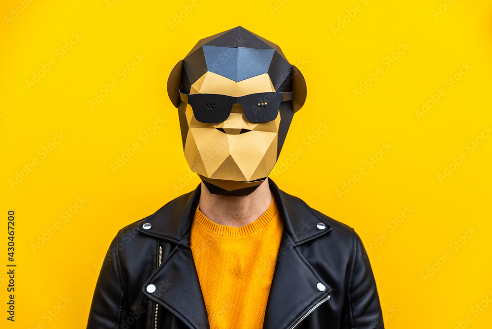 Man with funny low poly mask on colored background