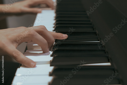 Woman playing a song on her piano 