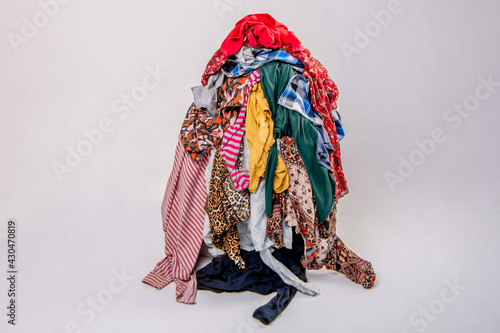 Pile of used clothes on a light background. Second hand for recycling photo