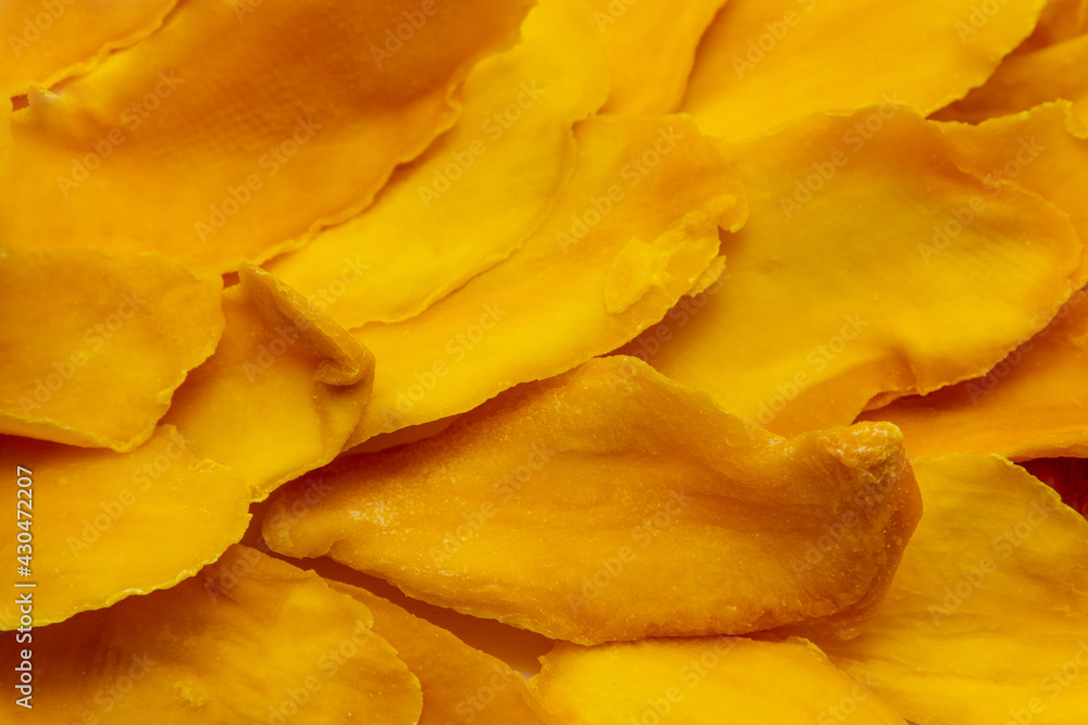 Closeup of many slices of dried mango without sugar. Background image. Closeup of many slices of dried mango without sugar. Background image.