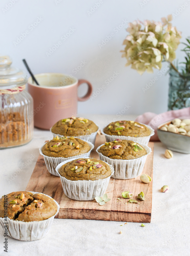 Vegan muffins with matches and pistachios on a wooden board. Delicious and healthy breakfast and snack. Vegan and vegetarian concept. 