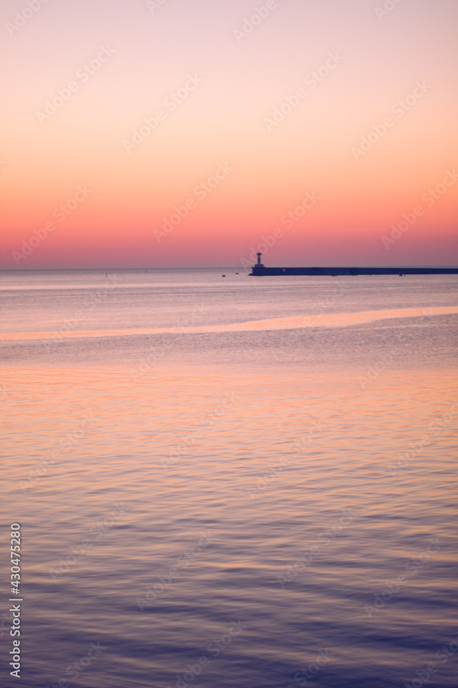 evening sunset on the Black Sea coast on the seaside boulevard of the hero city.