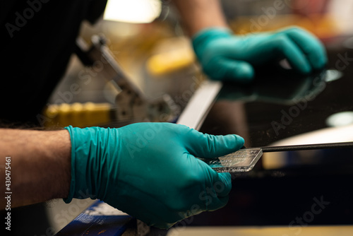 Check of components position on canopy glass in automotive plant photo