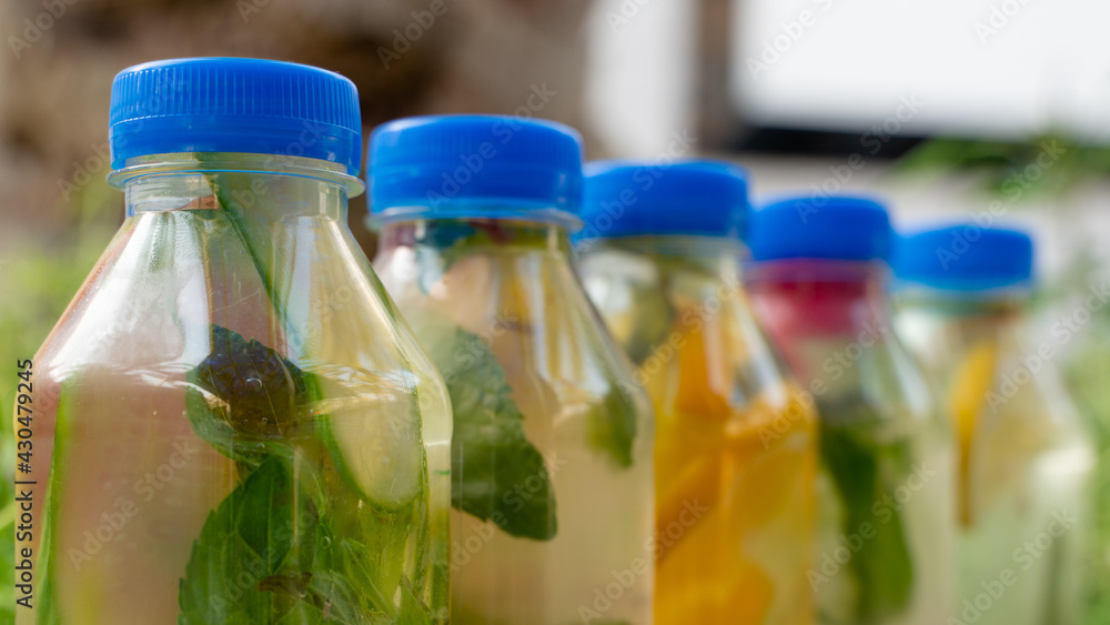 Variety of detox water on a plastic container, health concept