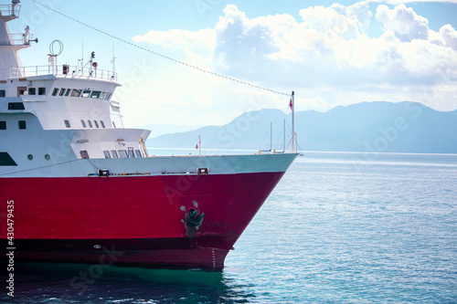 Large red cruise ship sailing on the sea photo