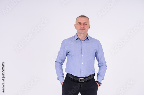 Man in blue shirt and black trousers on white background