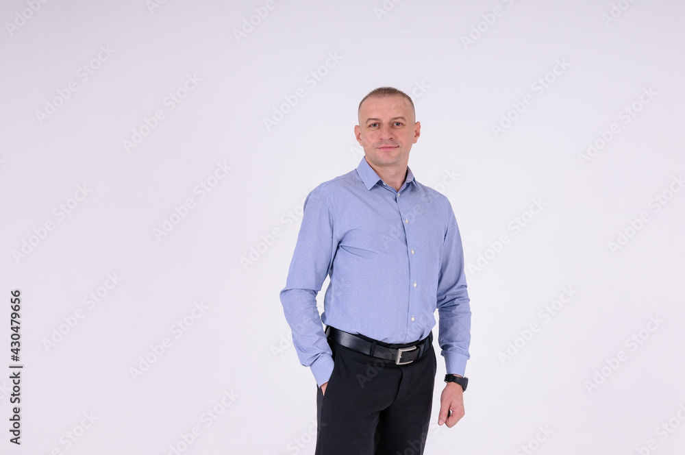 Man in blue shirt and black trousers on white background