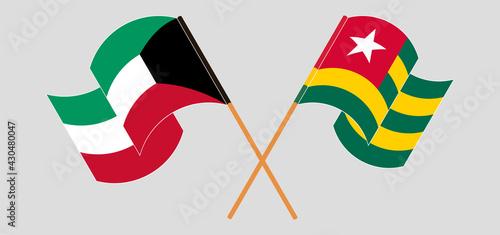 Crossed and waving flags of Kuwait and Togo