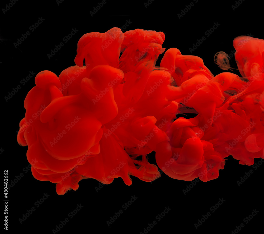 explosion of acrylic red paint in clear water. Black background explosion of acrylic red paint in clear water. Black background