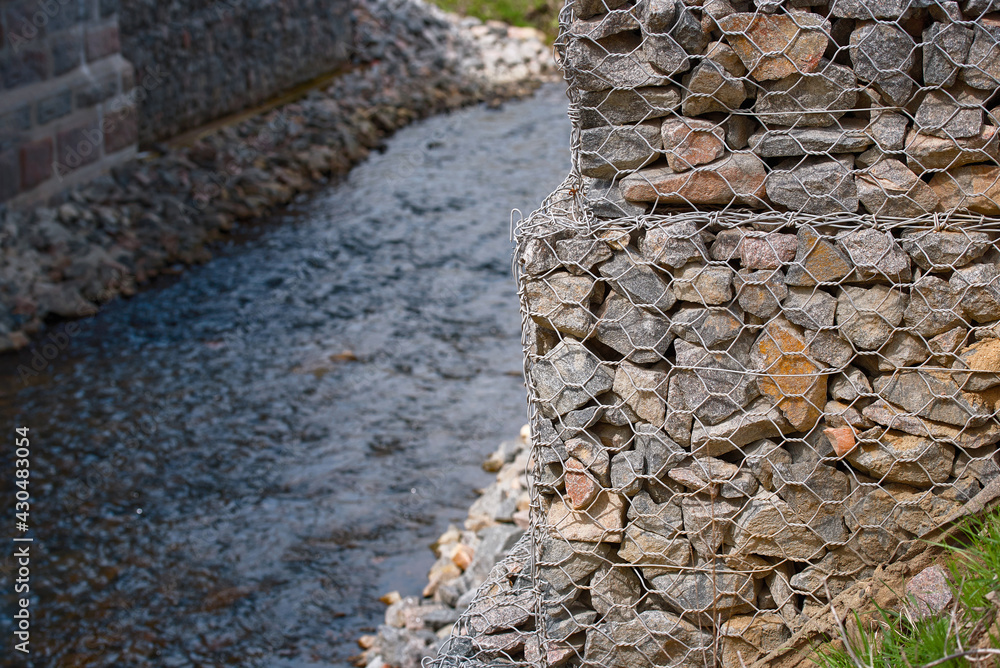 Foto de Bridge abutment with gabions. Gabion wall constructed using