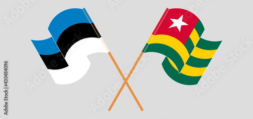Crossed and waving flags of Estonia and Togo