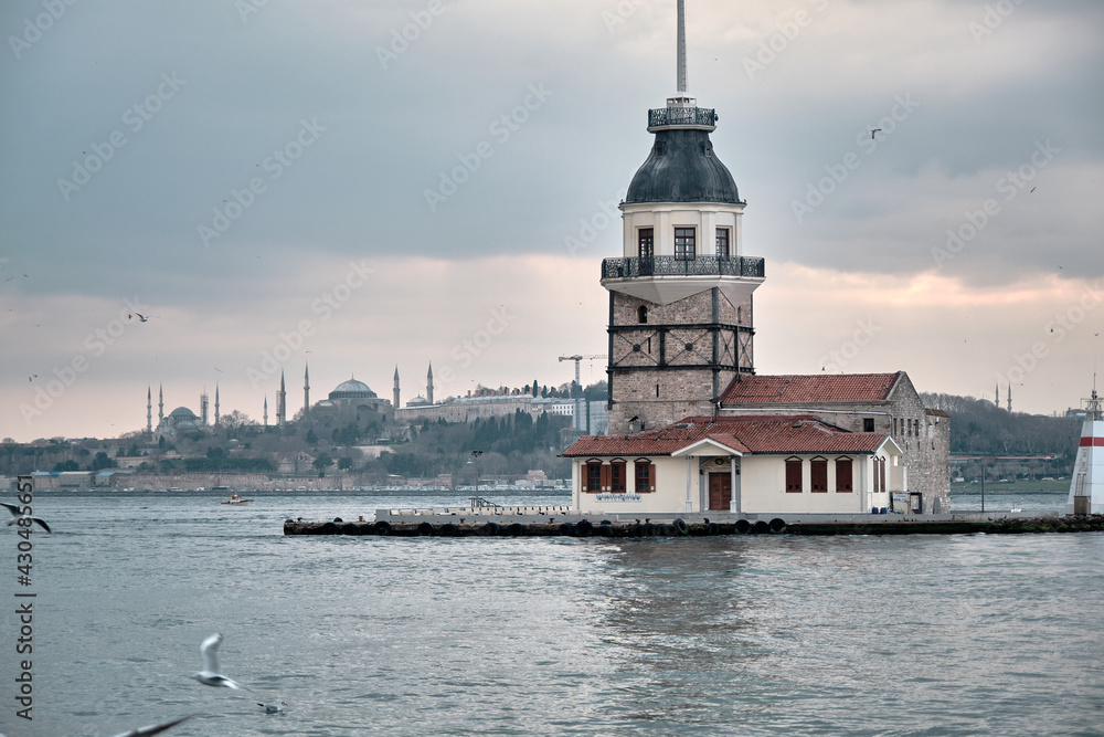 04.03.2021 istanbul Turkey. maiden tower during sunset and many seagulls flying in front of the tower with magnificent nature of turquoise water 04.03.2021 istanbul Turkey. maiden tower during sunset and many seagulls flying in front of the tower with magnificent nature of turquoise water