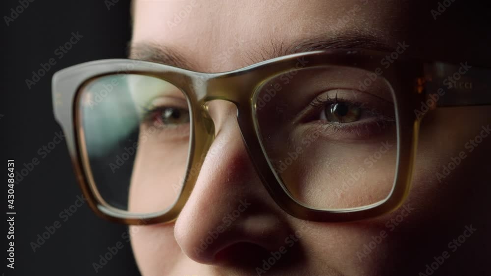 Portrait of young businesswoman smiling on black background.Girl wearing glasses Portrait of young businesswoman smiling on black background.Girl wearing glasses