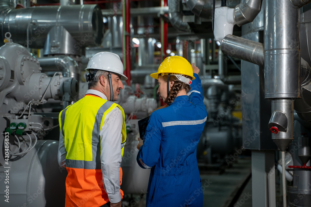 Engineer with technical worker checking and working at large industry factory. Engineer with technical worker checking and working at large industry factory.