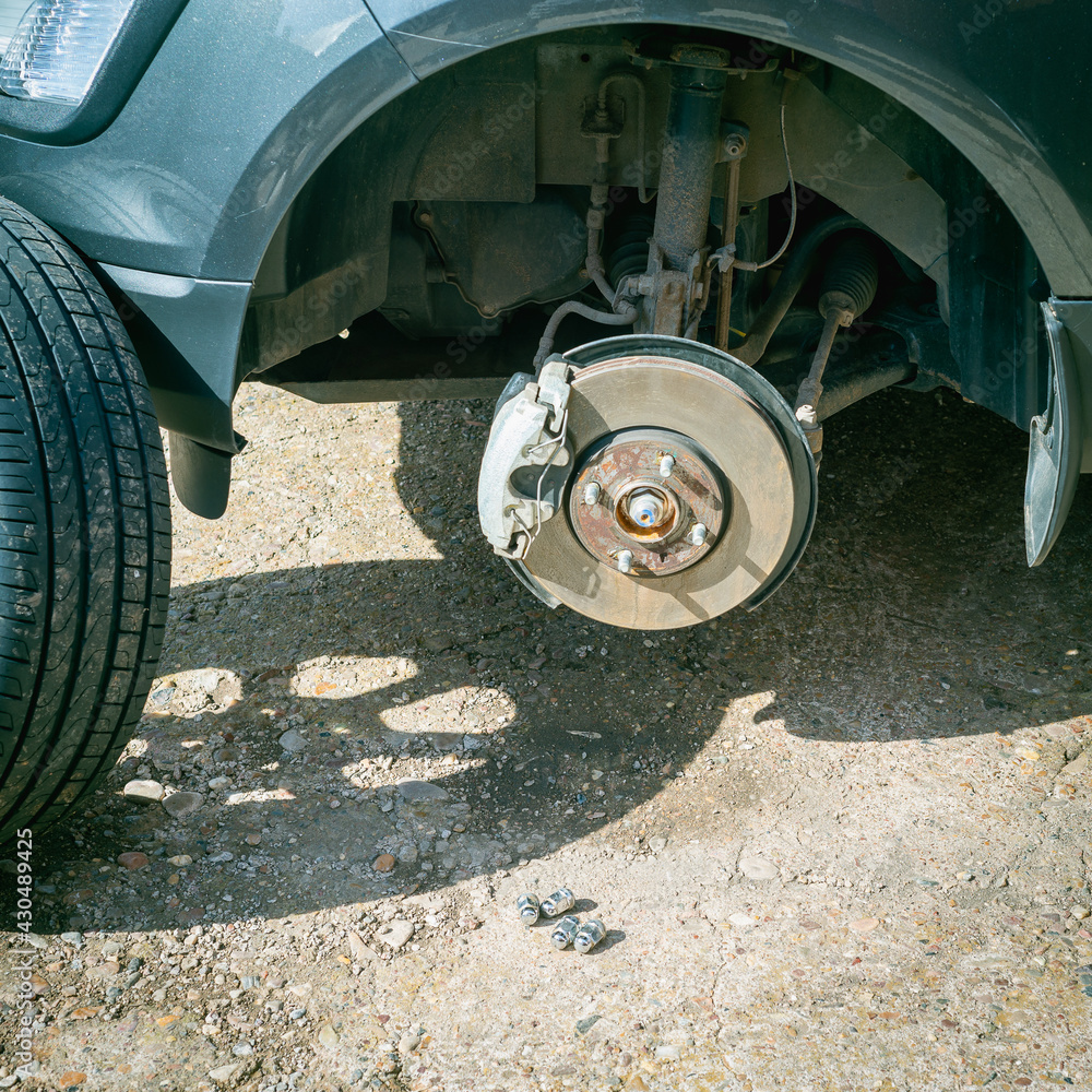 Replacing a punctured wheel on a car. Replacing a punctured wheel on a car.