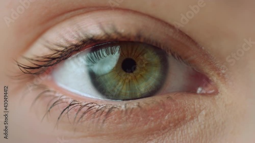 Macro video of female right eye.Extremely close up view of motion woman blue eye