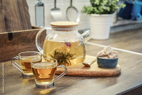 Blooming flowering tea in glass teapot photo