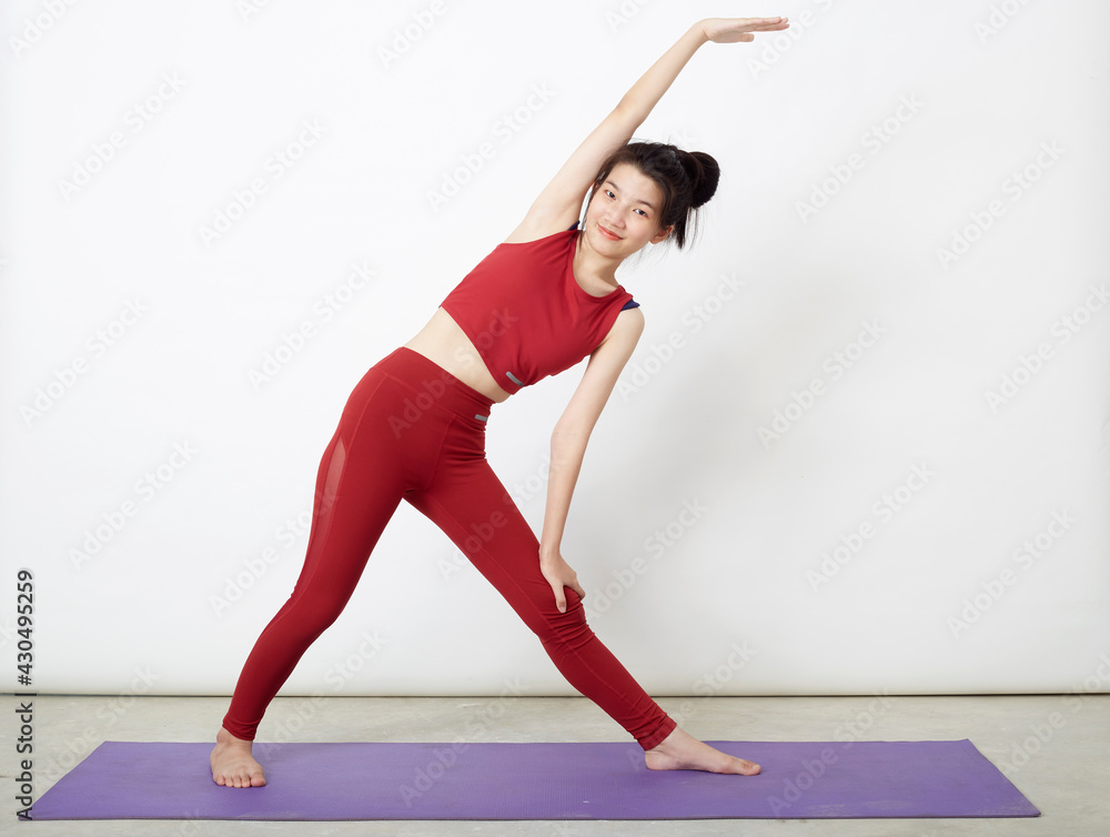 woman making yoga pose on mat