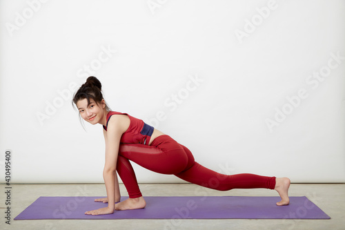 woman making yoga pose on mat
