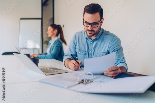 Businessman doing paperwork in the office photo