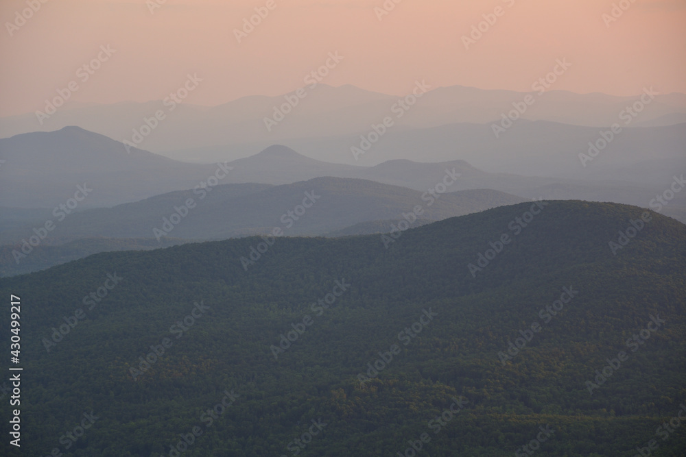 Mountain silhouette during sunset on a hot summer day with very high humidity