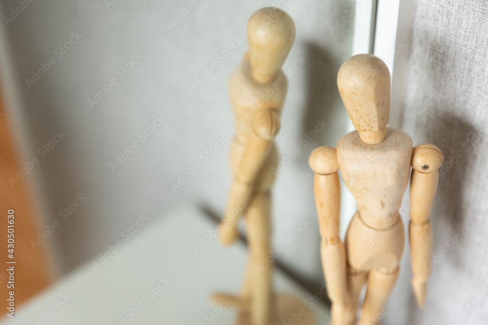 Mind concept, wooden puppet reflection in mirror Mind concept, wooden puppet reflection in mirror