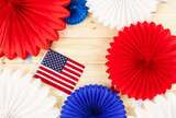Decorations for 4th of July day of American independence, flag, candles, straws, paper fans. USA holiday decorations on a wooden background, top view, flat lay