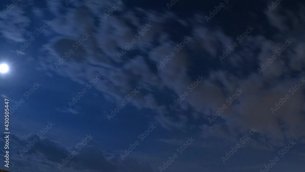 Time lapse of night sky with moon and storm clouds approaching with lightning Time lapse of night sky with moon and storm clouds approaching with lightning