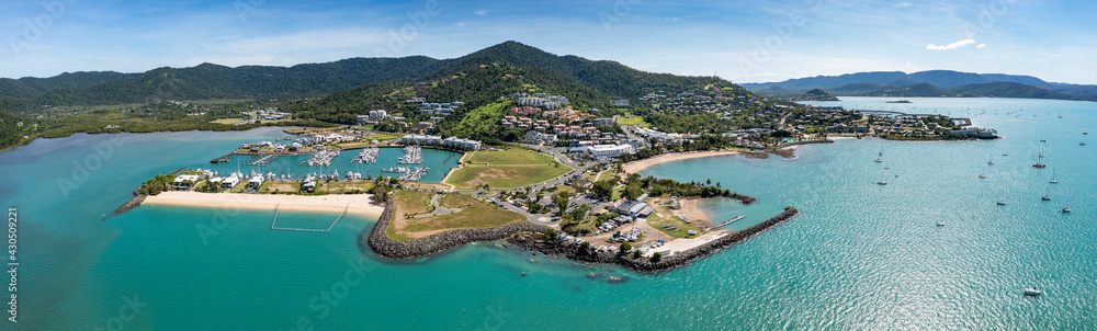 Aerial panoramic afternoon view of beautiful Airlie Beach in Queensland Australia, a popular tourist destination.