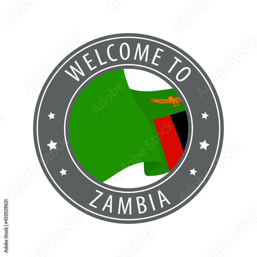 Welcome to Zambia. Gray stamp with a waving country flag. photo